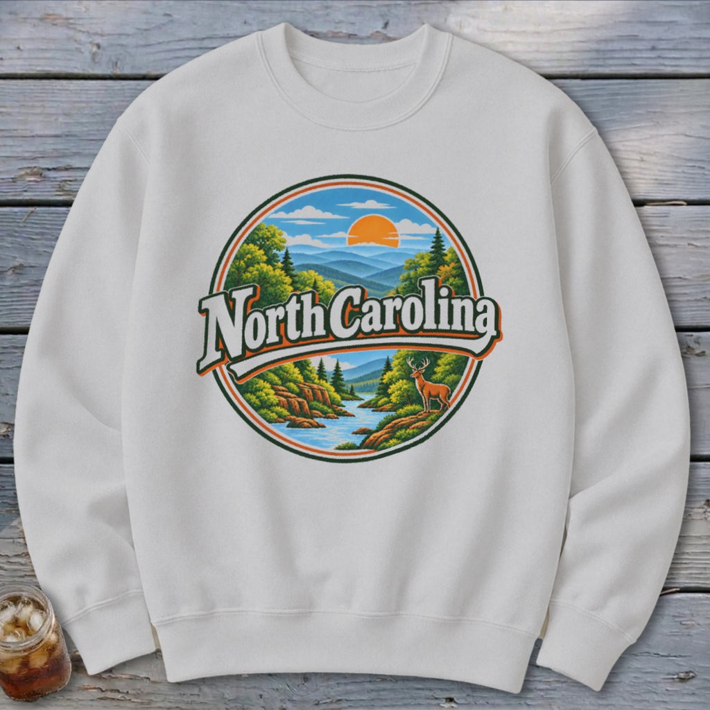White sweatshirt with circular North Carolina mountain landscape graphic and deer.