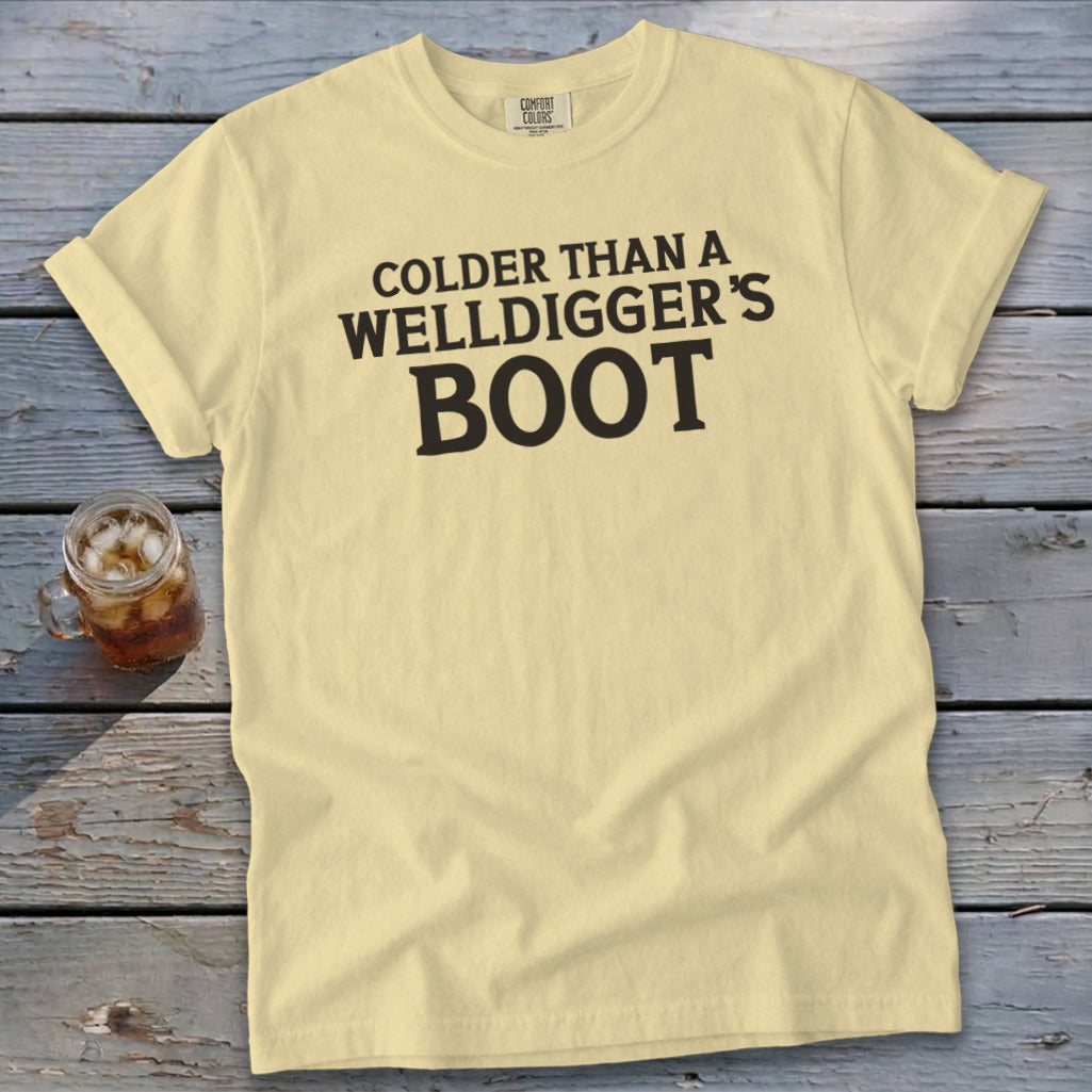 Pale yellow t-shirt with black text reading "Colder than a Welldigger's Boot".