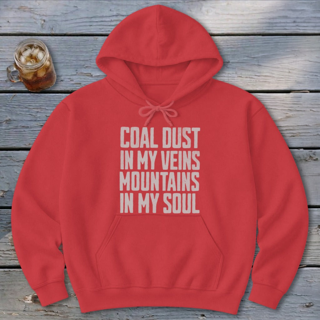 A red hooded sweatshirt with white text reading COAL DUST IN MY VEINS MOUNTAINS IN MY SOUL.