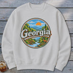White sweatshirt with circular Georgia nature graphic featuring deer and mountains.