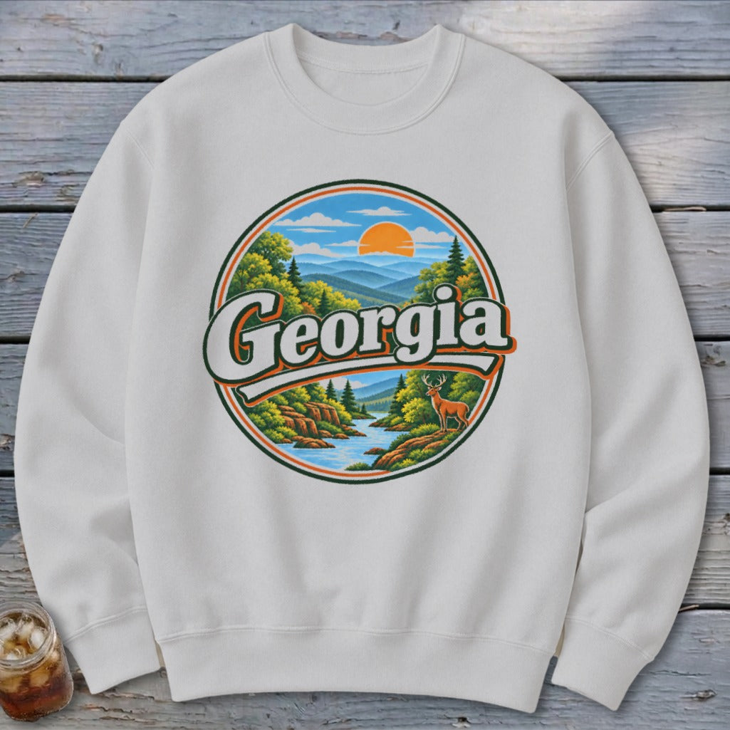 White sweatshirt with circular Georgia nature graphic featuring deer and mountains.
