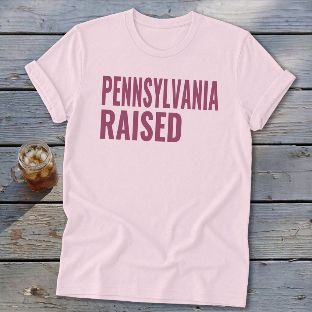 Light pink t-shirt with "PENNSYLVANIA RAISED" printed in maroon.