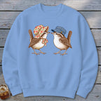 Two wrens, one in a floral bonnet, the other in a striped cap, look at each other.