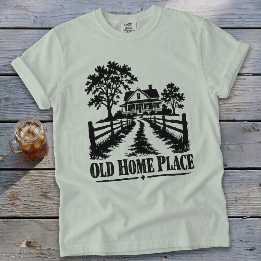 T-shirt with a farmhouse, trees, fence, and text "OLD HOME PLACE".