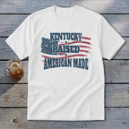 White t-shirt with "Kentucky Raised American Made" and distressed American flag graphic.