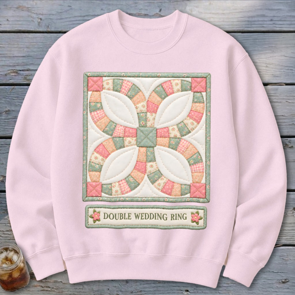 Pink sweatshirt featuring a Double Wedding Ring quilt block graphic with text.