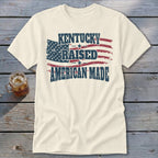 Cream t-shirt with American flag graphic and text "Kentucky Raised American Made".