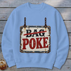 Light blue crewneck sweatshirt featuring a graphic of a wooden sign that reads "BAG POKE".