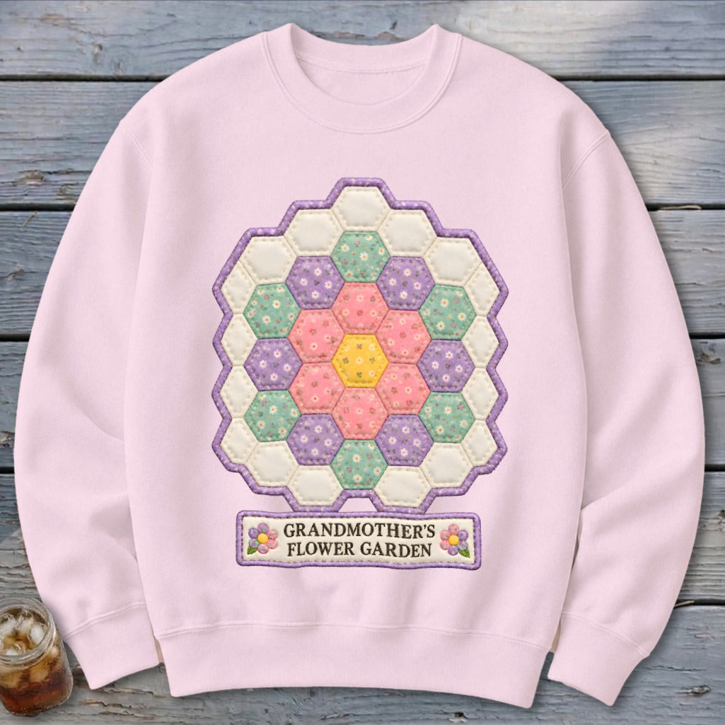 Pink sweatshirt with hexagonal patchwork flower design and "Grandmother's Flower Garden" text.