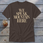 Brown t-shirt with "WE SPEAK MOUNTAIN HERE" text in cream.