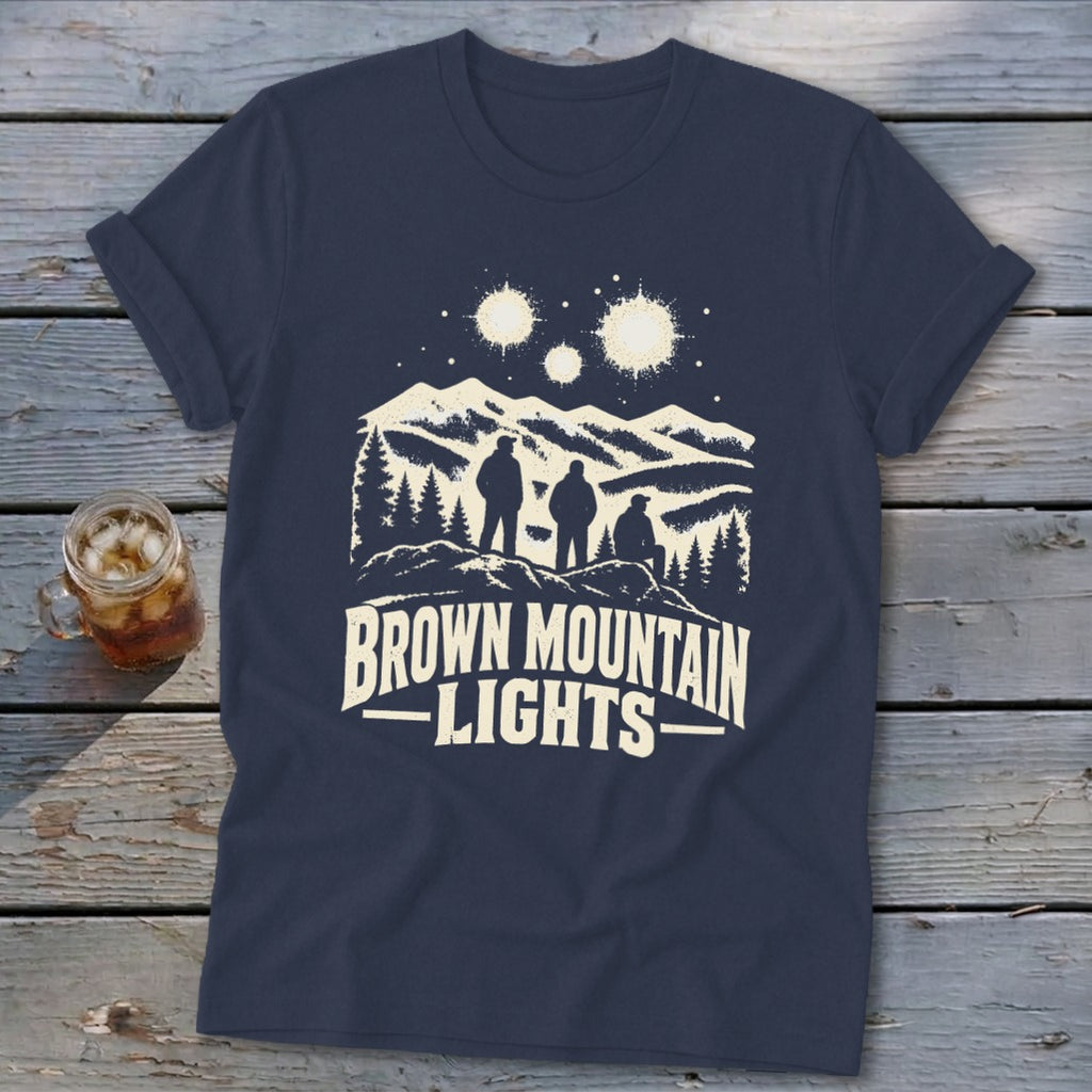 A dark blue t-shirt with a graphic of three figures looking at mountain lights.