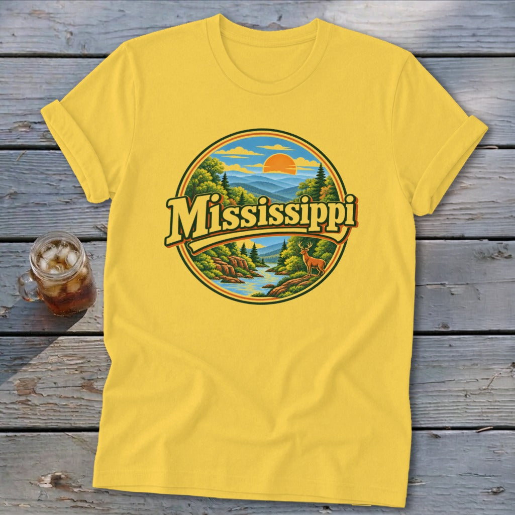 Yellow t-shirt with circular design featuring "Mississippi" text, mountains, river, and deer.