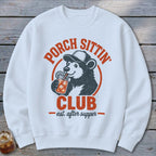 White sweatshirt with bear drinking from jar, "Porch Sittin' Club" text.