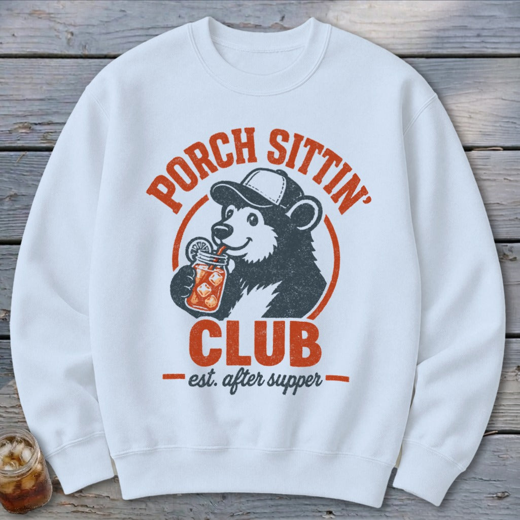 White sweatshirt with bear drinking from jar, "Porch Sittin' Club" text.