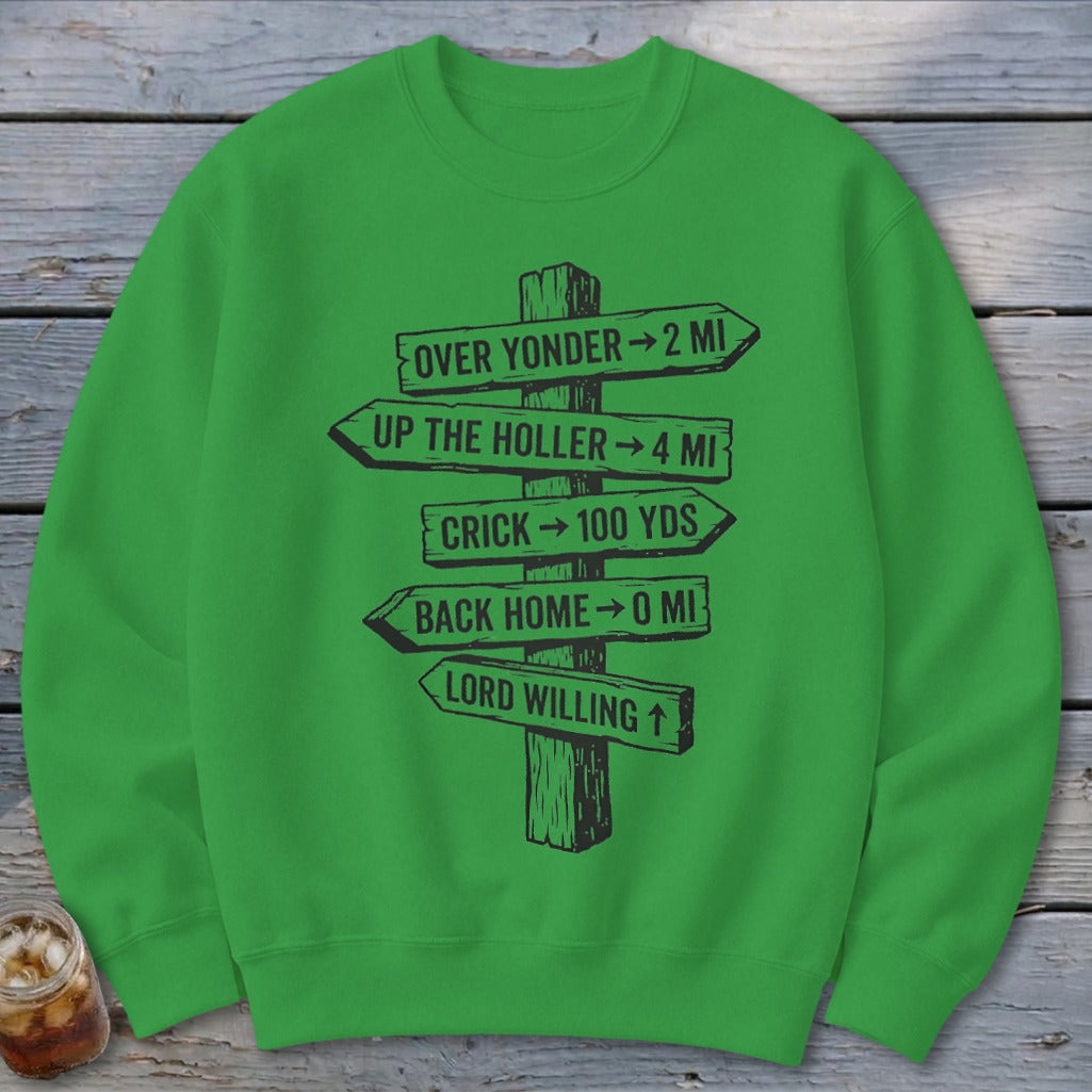 A bright green crewneck sweatshirt featuring a black graphic of a wooden signpost with directional text.