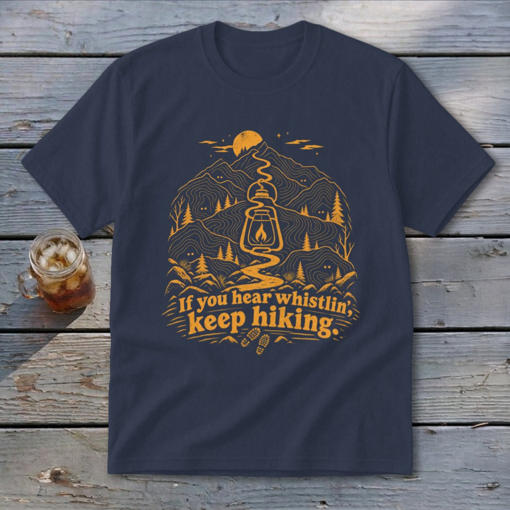Navy t-shirt with orange mountain landscape, lantern, and text: "If you hear whistlin', keep hiking."