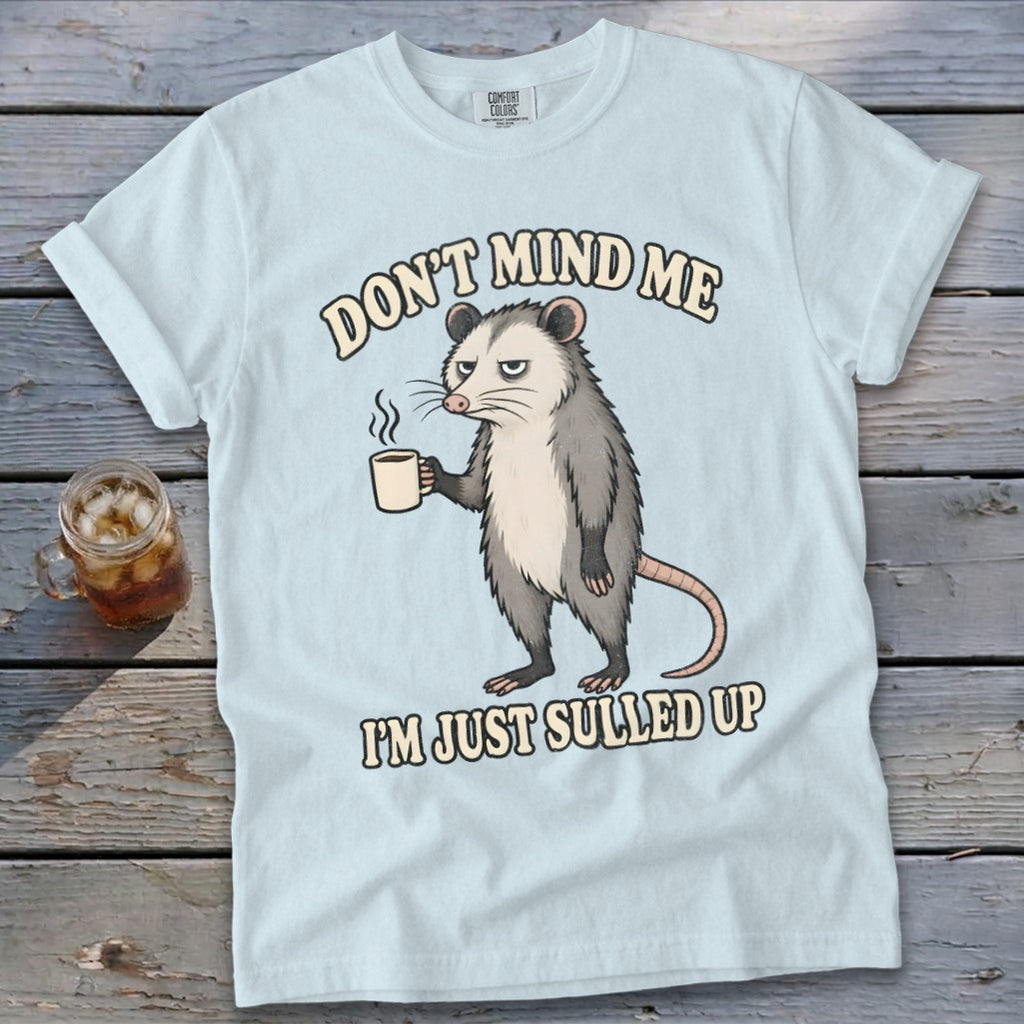 Light blue t-shirt with possum holding coffee mug and text "DON'T MIND ME I'M JUST SULLED UP".