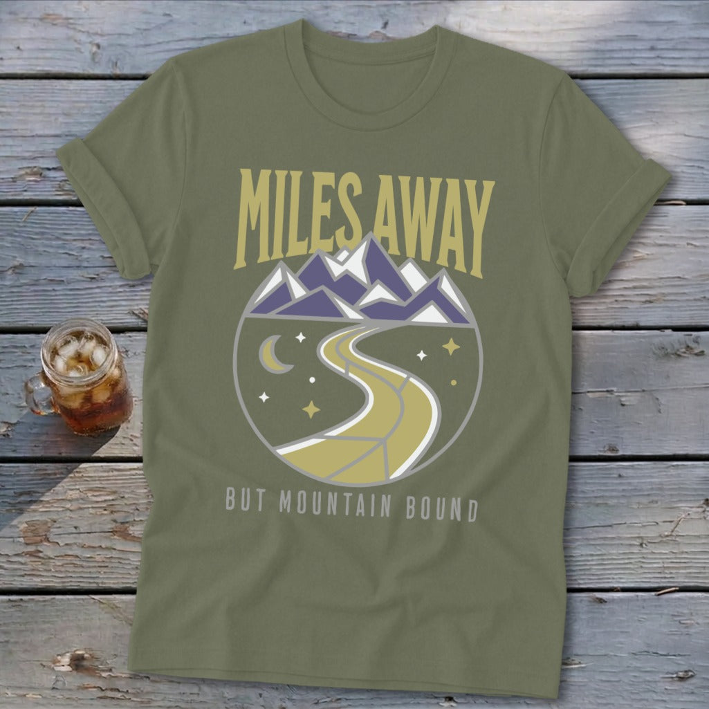 Olive green t-shirt with "Miles Away But Mountain Bound" text and mountain graphic.