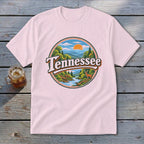 Pink t-shirt with a circular graphic depicting a Tennessee landscape with text.