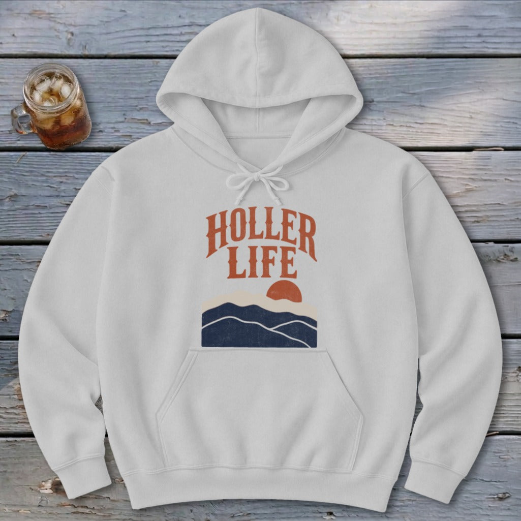 Light gray hooded sweatshirt with the text HOLLER LIFE above blue mountains and an orange sun.