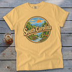 Yellow t-shirt with "South Carolina" text and scenic mountain landscape graphic.