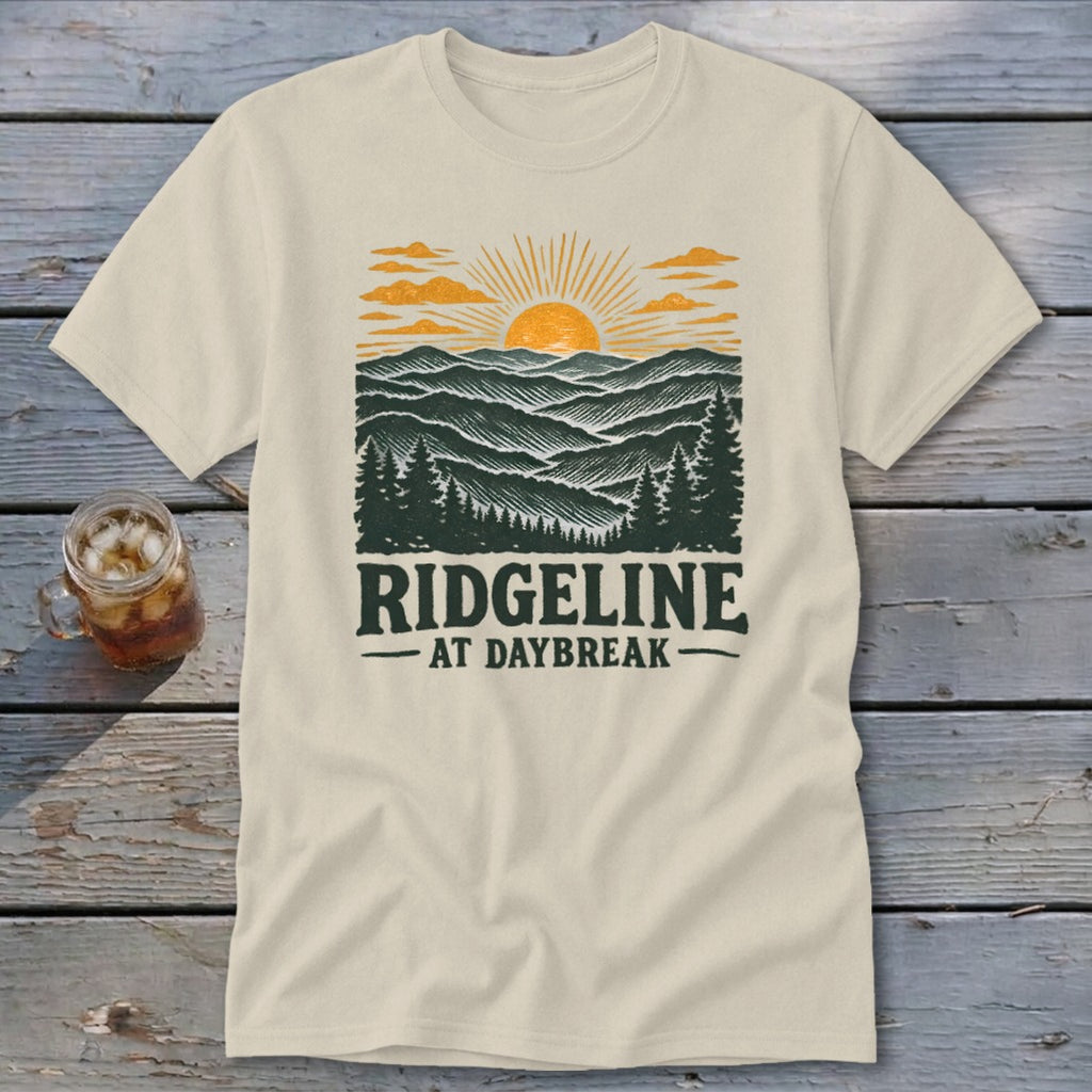 Cream t-shirt with a mountain landscape and "RIDGELINE AT DAYBREAK" text.