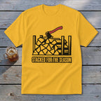 Yellow t-shirt with black graphic of stacked firewood and axe, text "Stacked for the Season".