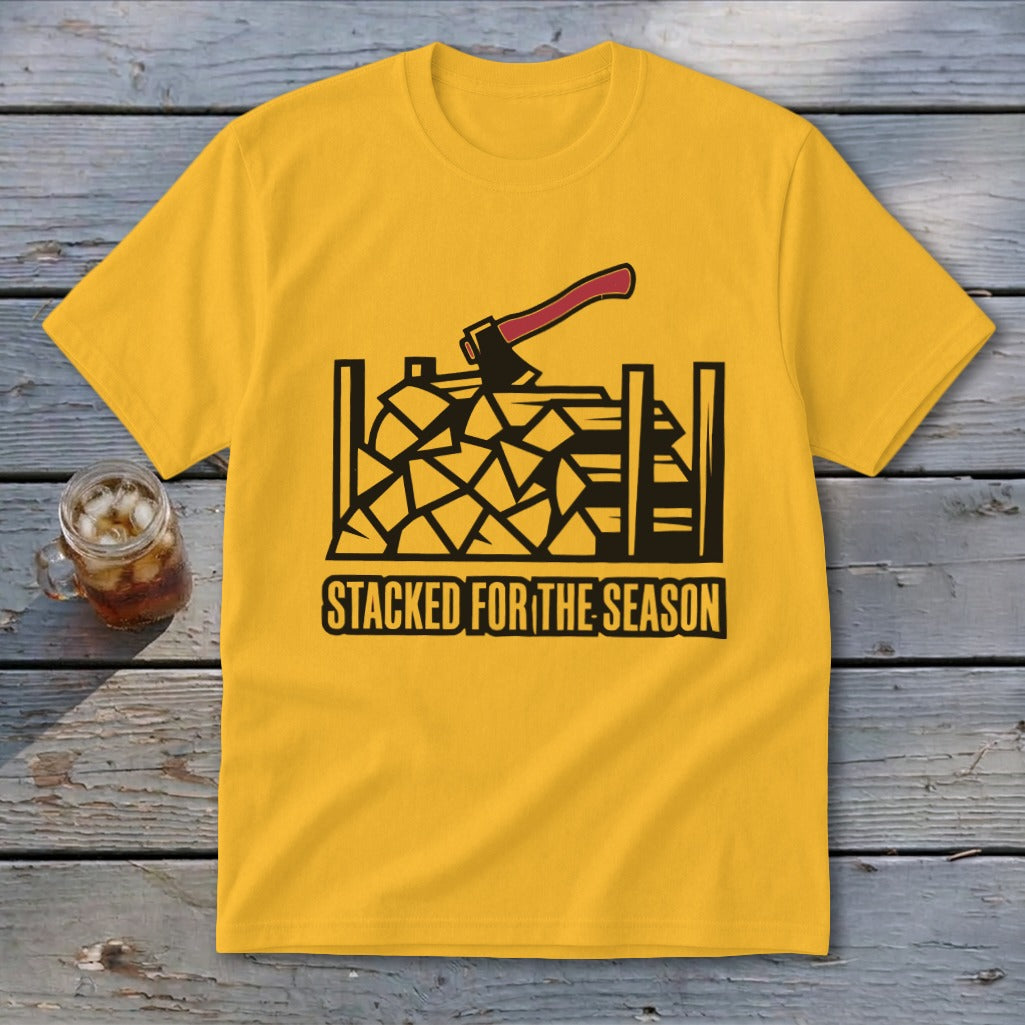 Yellow t-shirt with black graphic of stacked firewood and axe, text "Stacked for the Season".