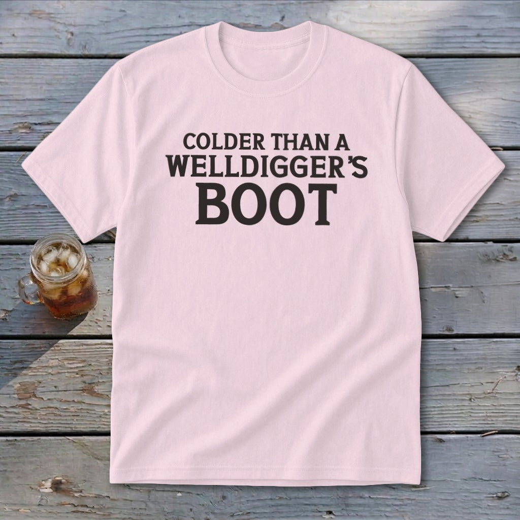 Pink t-shirt with black text reading "Colder Than A Welldigger's Boot".