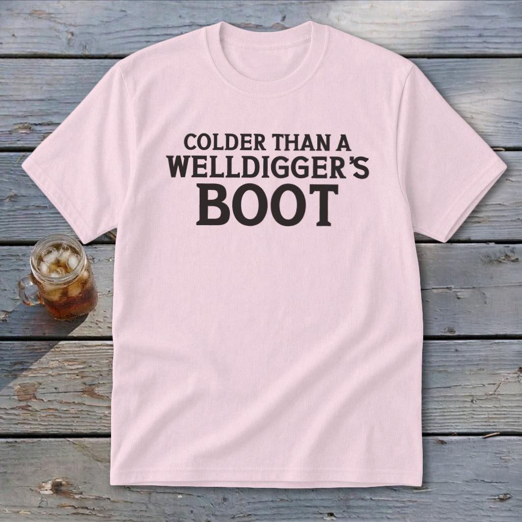Pink t-shirt with black text reading "Colder Than A Welldigger's Boot".