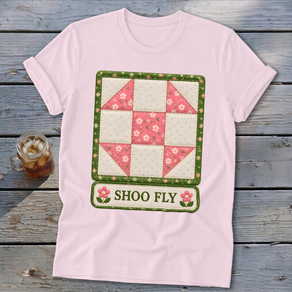 Pink t-shirt with a "Shoo Fly" quilt block design and floral accents.