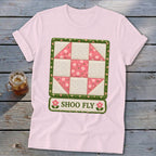 Pink t-shirt with a "Shoo Fly" quilt block design and floral accents.