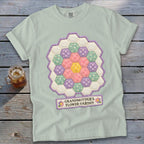 Light green t-shirt with a hexagonal patchwork flower design and "GRANDMOTHER'S FLOWER GARDEN" text.