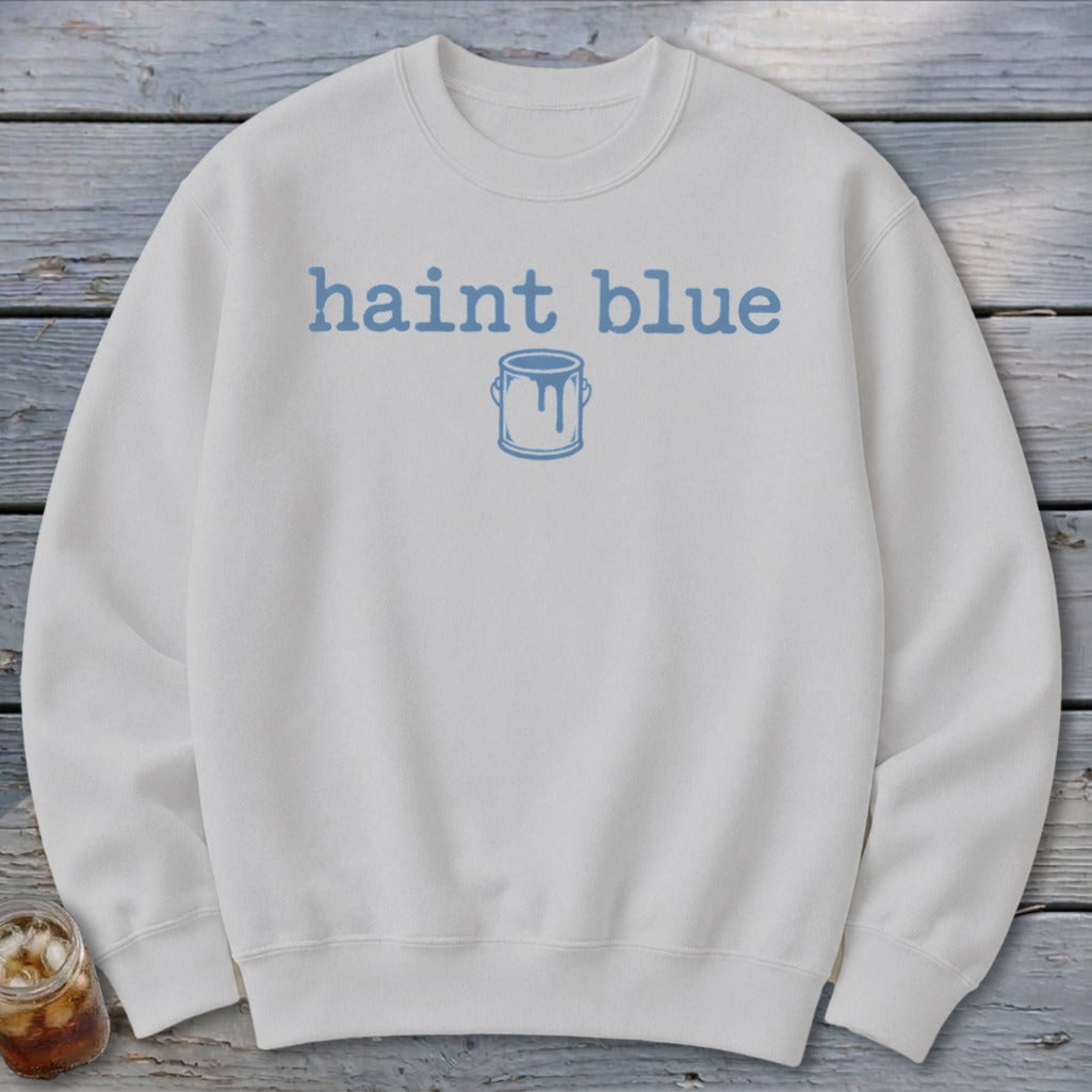 White sweatshirt with "haint blue" text and a paint can graphic.