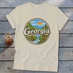 Cream t-shirt with a circular Georgia mountain and river graphic featuring a deer.
