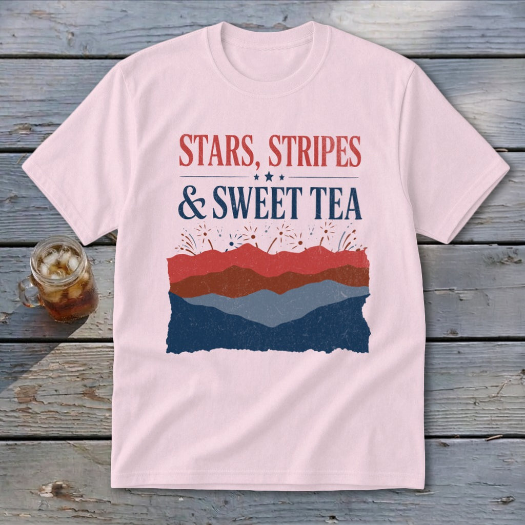 Light pink t-shirt featuring the text "Stars, Stripes & Sweet Tea" above layered red, brown, and blue graphics.