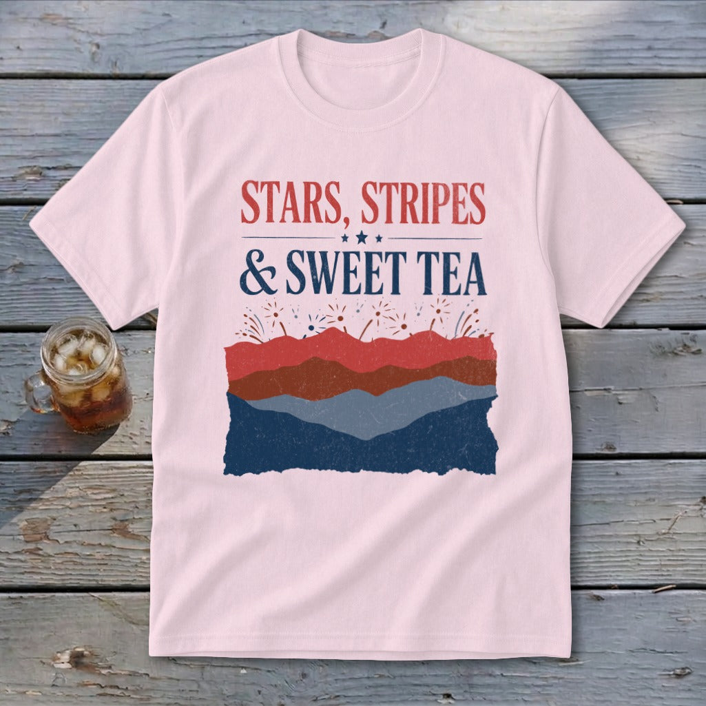 Light pink t-shirt featuring the text "Stars, Stripes & Sweet Tea" above layered red, brown, and blue graphics.