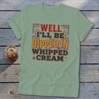 Green t-shirt with "WELL I'LL BE DIPPED IN WHIPPED CREAM" text graphic.