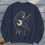 Bear playing a banjo while sitting on a stool.