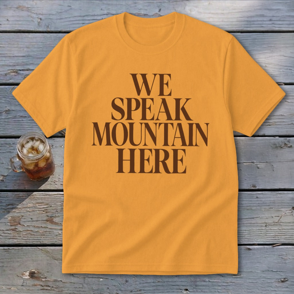 Orange t-shirt with brown text "WE SPEAK MOUNTAIN HERE".