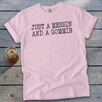 Pink t-shirt with black text reading "JUST A MESSIN AND A GOMMIN".