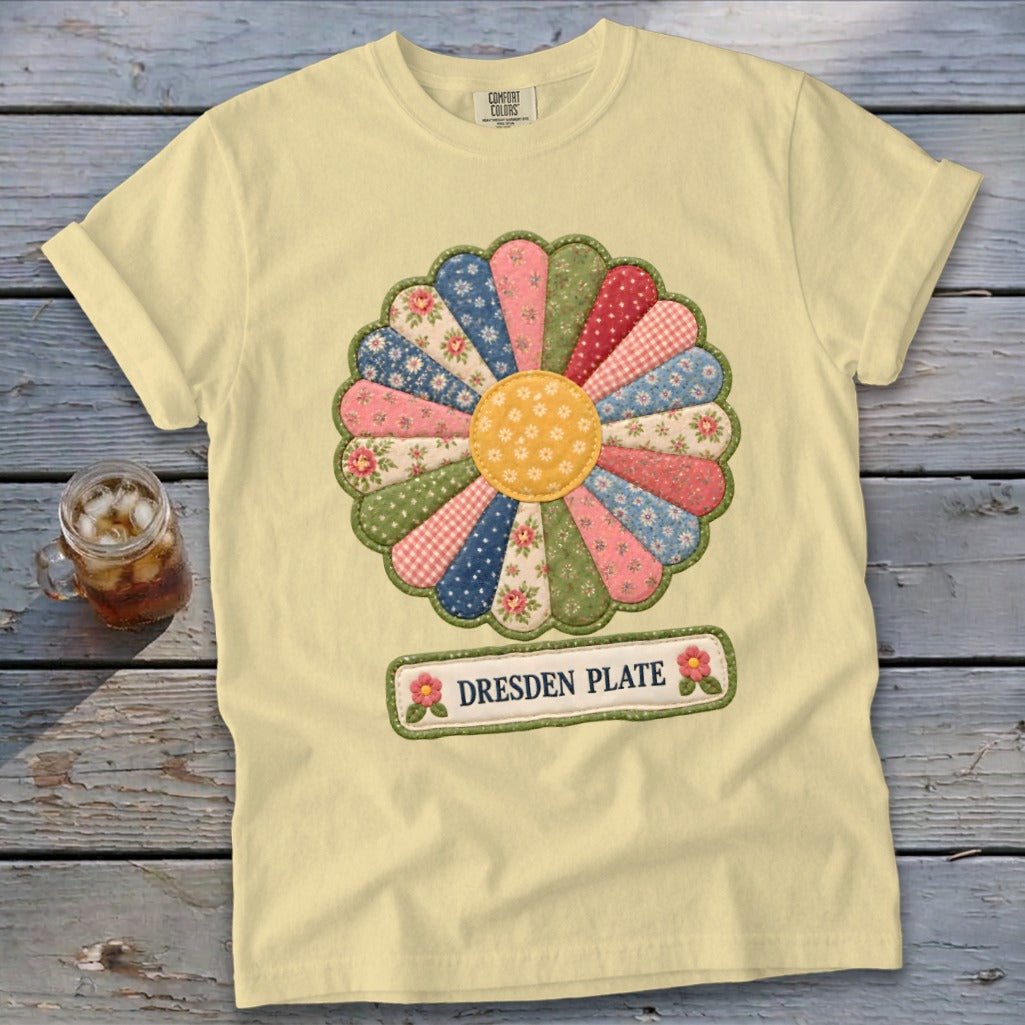 Pale yellow t-shirt with a colorful Dresden Plate quilt design and embroidered text.