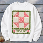 White sweatshirt with a quilted Shoo Fly block design and text.