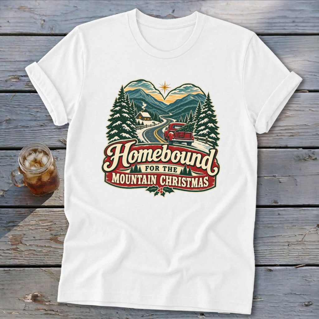 White t-shirt with "Homebound For The Mountain Christmas" graphic featuring a red truck and mountains.