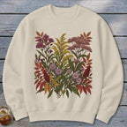Cream sweatshirt with a botanical print of autumn wildflowers and foliage.
