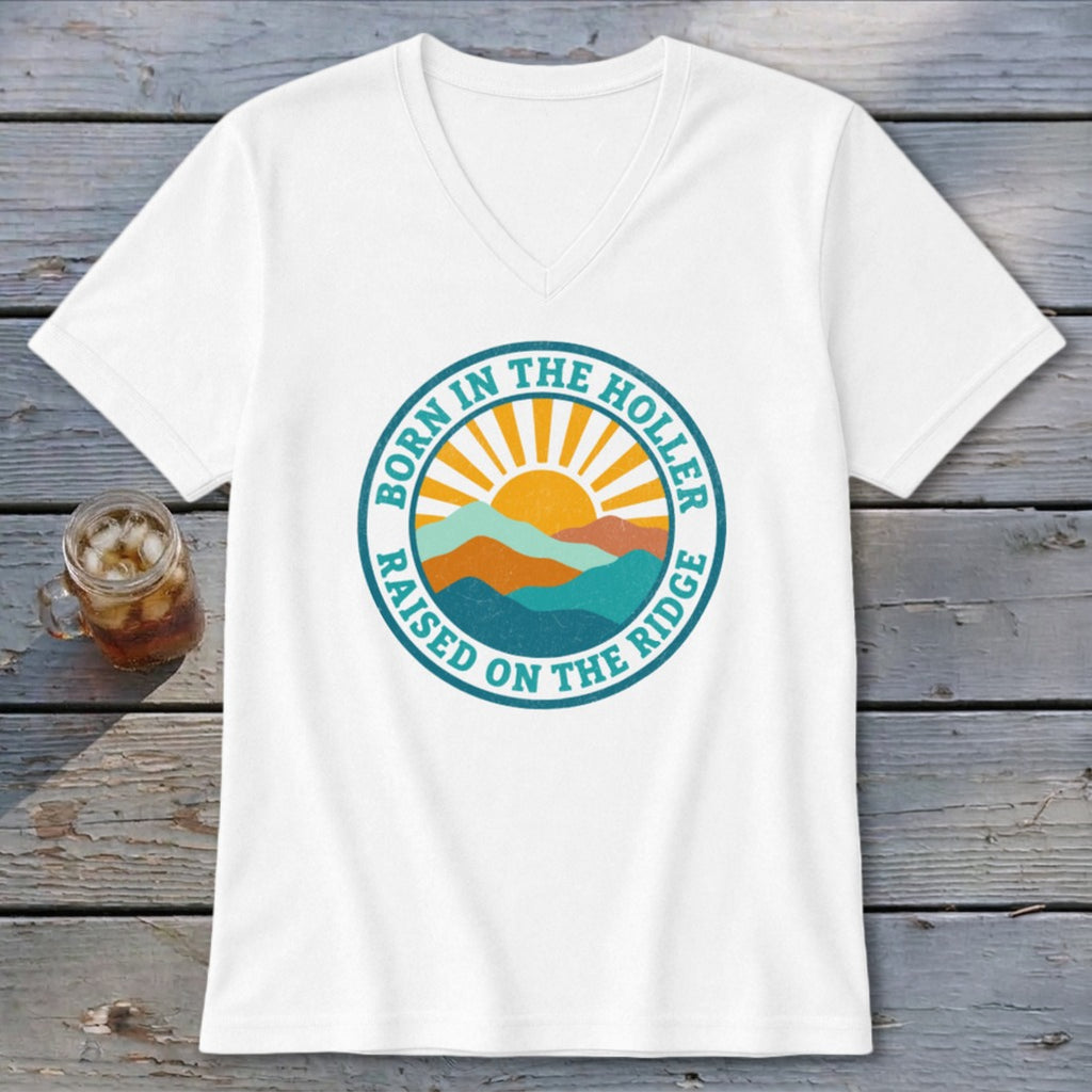 White V-neck t-shirt featuring a retro mountain graphic with the text Born in the Holler Raised on the Ridge.