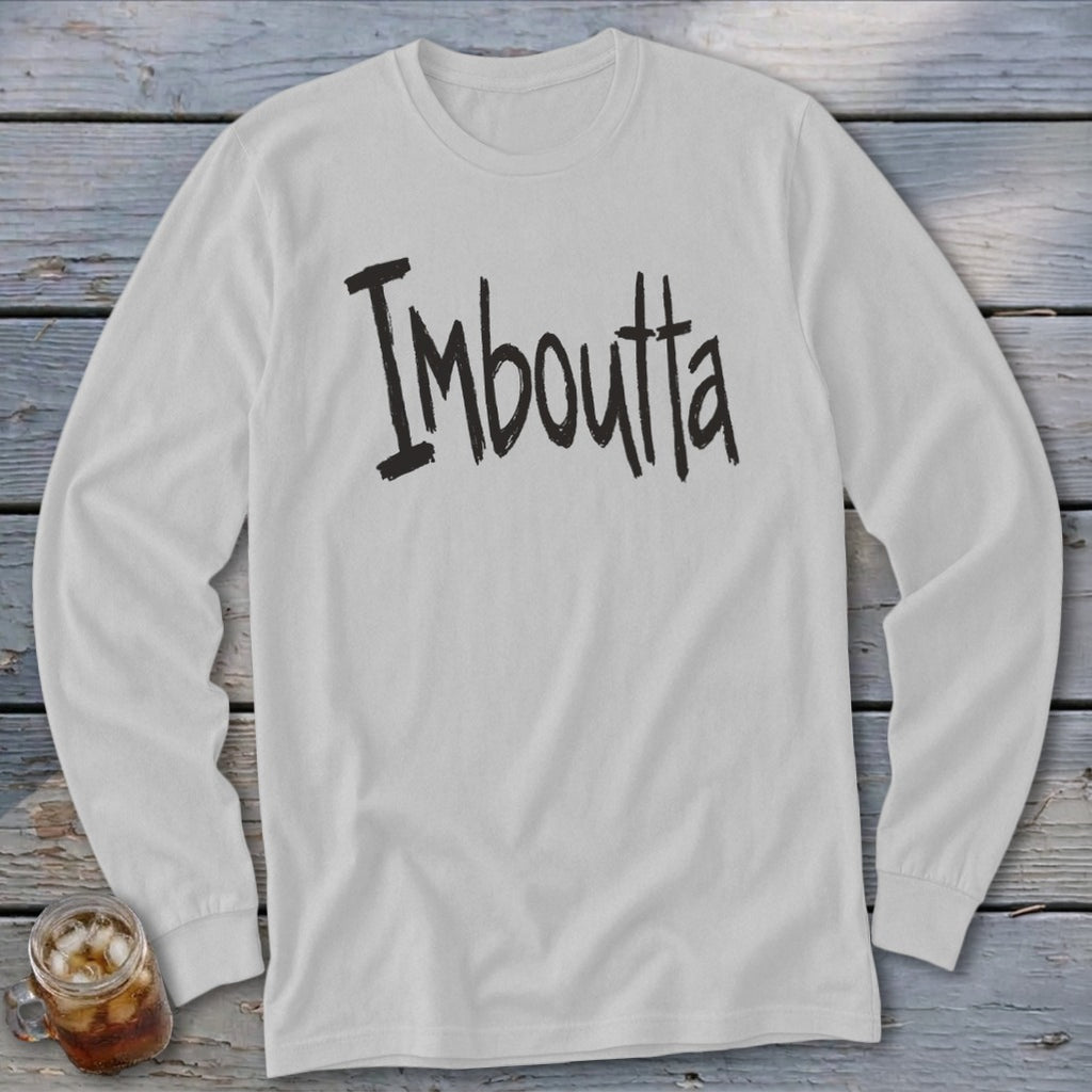White long-sleeved shirt with black distressed text "Imboutta" and a glass of iced tea.