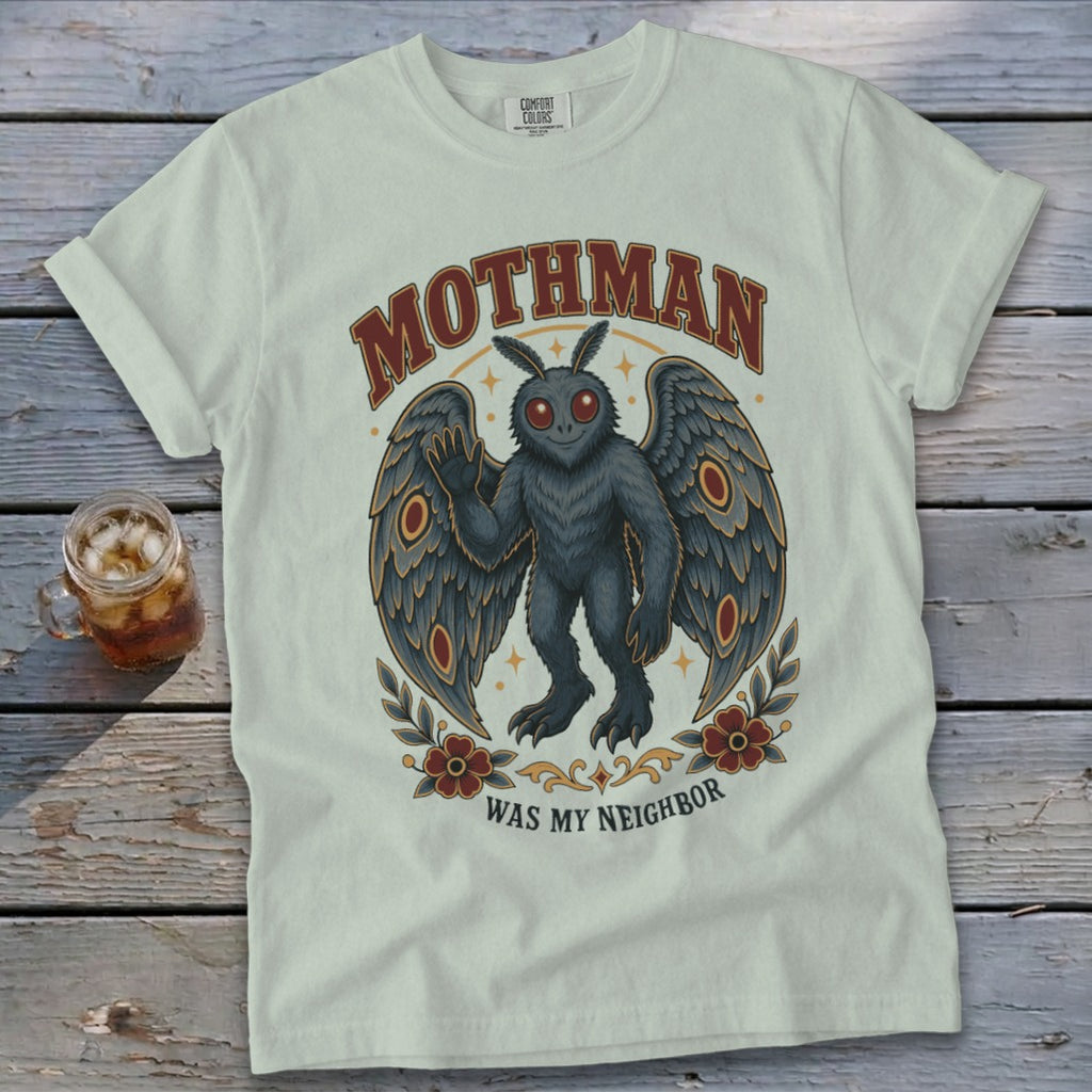 Mothman graphic and text design on a light colored t-shirt.