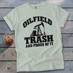 Light green t-shirt with black text and oil pump graphic: "OILFIELD TRASH AND PROUD OF IT".