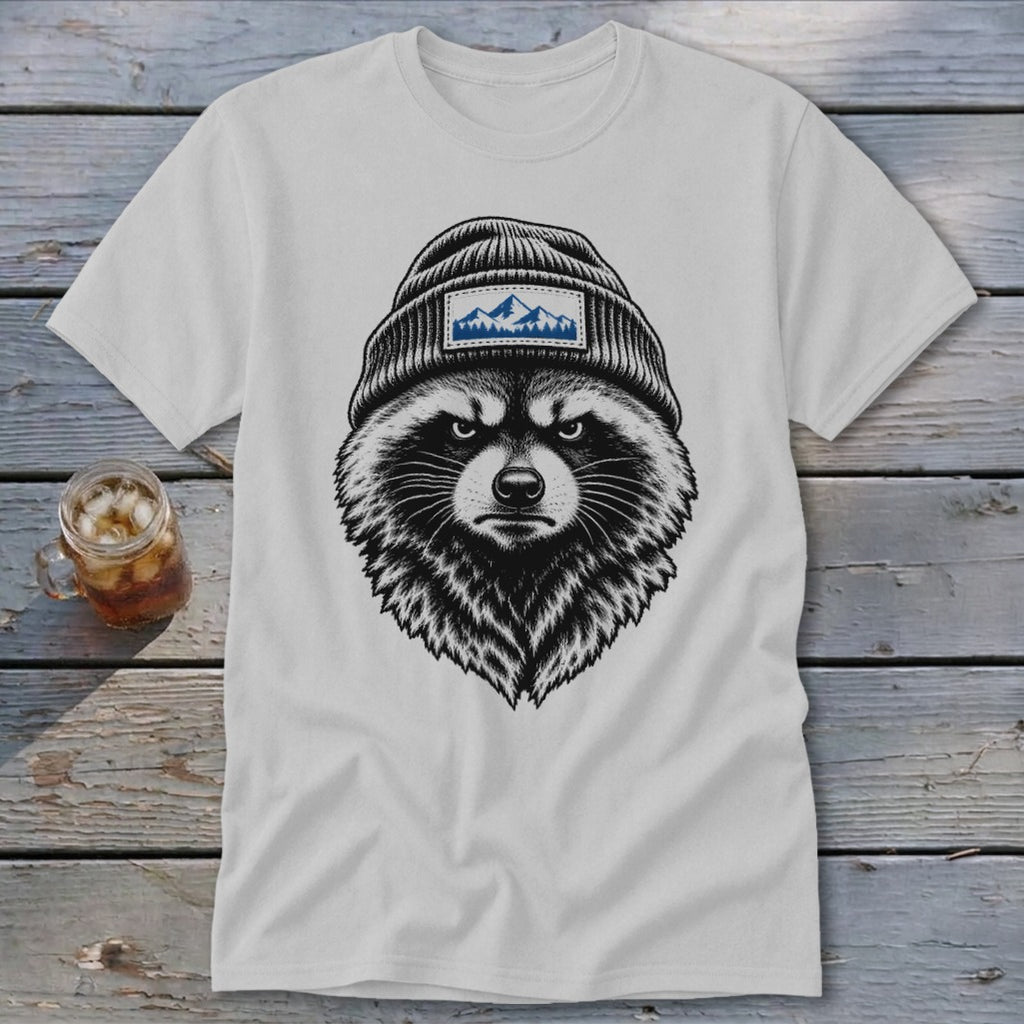 White t-shirt featuring a black and white illustration of a raccoon wearing a beanie with mountains.